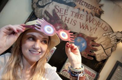 Irish actress Evanna Lynch, known for her role as Luna Lovegood in the Harry Potter film series, stopped to admire the Quibbler display and try on a pair of Spectrespecs at Dervish and Banges, a magical supplies and equipment shop at The Wizarding World of Harry Potter on Monday, July 18, 2011. Lynch was hosted by Universal Orlando Resort, spending some time at the theme parks while attending a Harry Potter fan conference in Orlando. Lynch played a role in the final installment of the Harry Potter film seri
