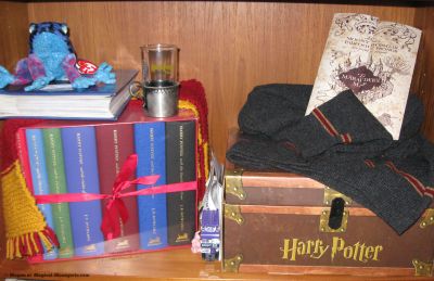 Maurader's Map
Gryffindor scarf mady by me
Polyjuice Potion Glass from CoS Promotion
Harry Potter Hardcover book sin Chest
UK Special Edition Books
Gryffindor Sweater from Lochaven International (got before they sold to general public)
LEGO Knight Bus
(the blue book is my photos from the HBP premiere)
